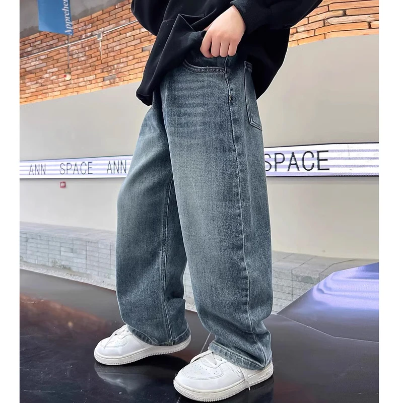 A product photo from AliExpress: a child wearing blue jeans against a textured wall — the kind of product card the parser pulls out of the search HTML.